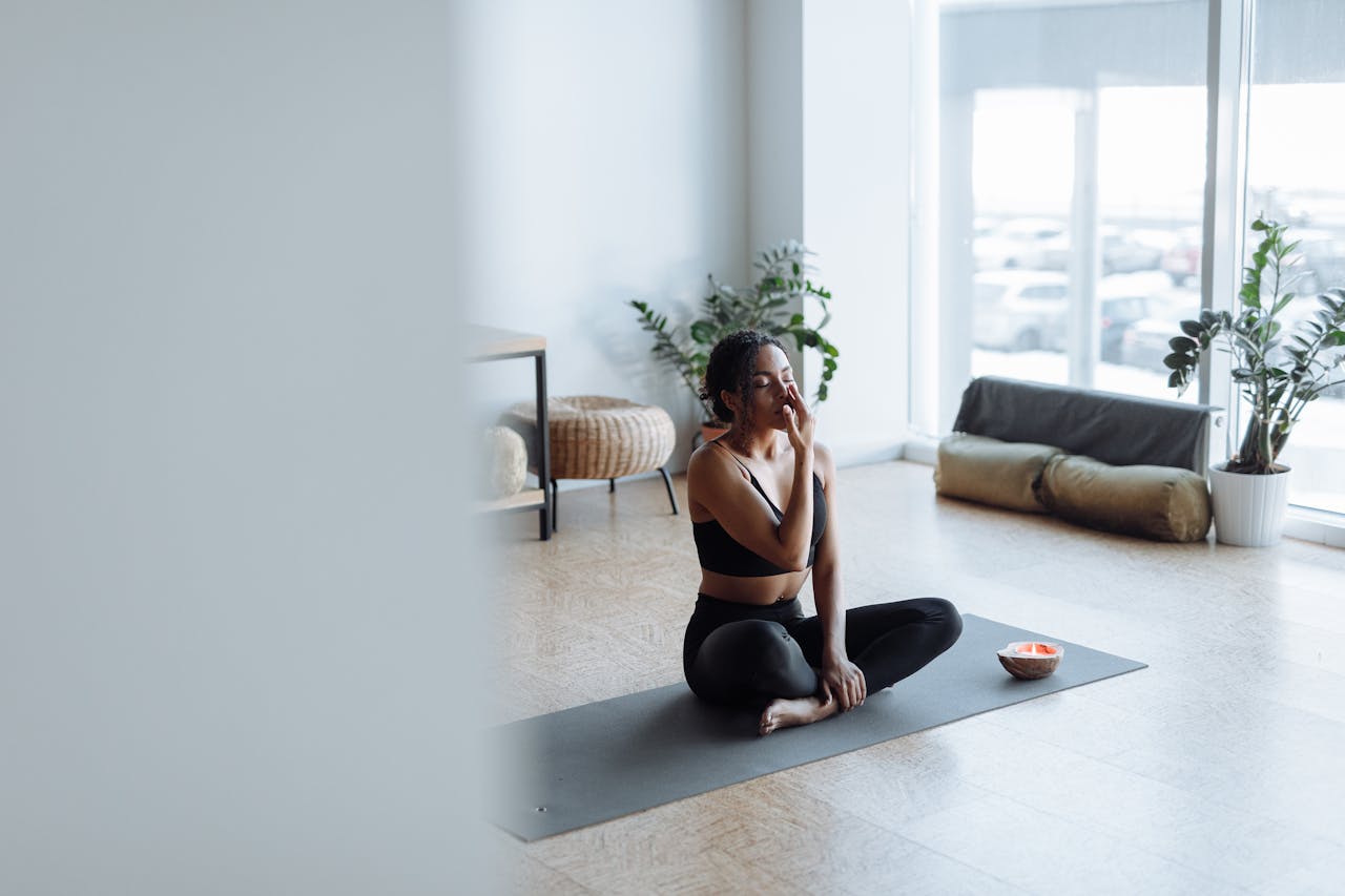 A women sitting next to a mindful candle for meditation.